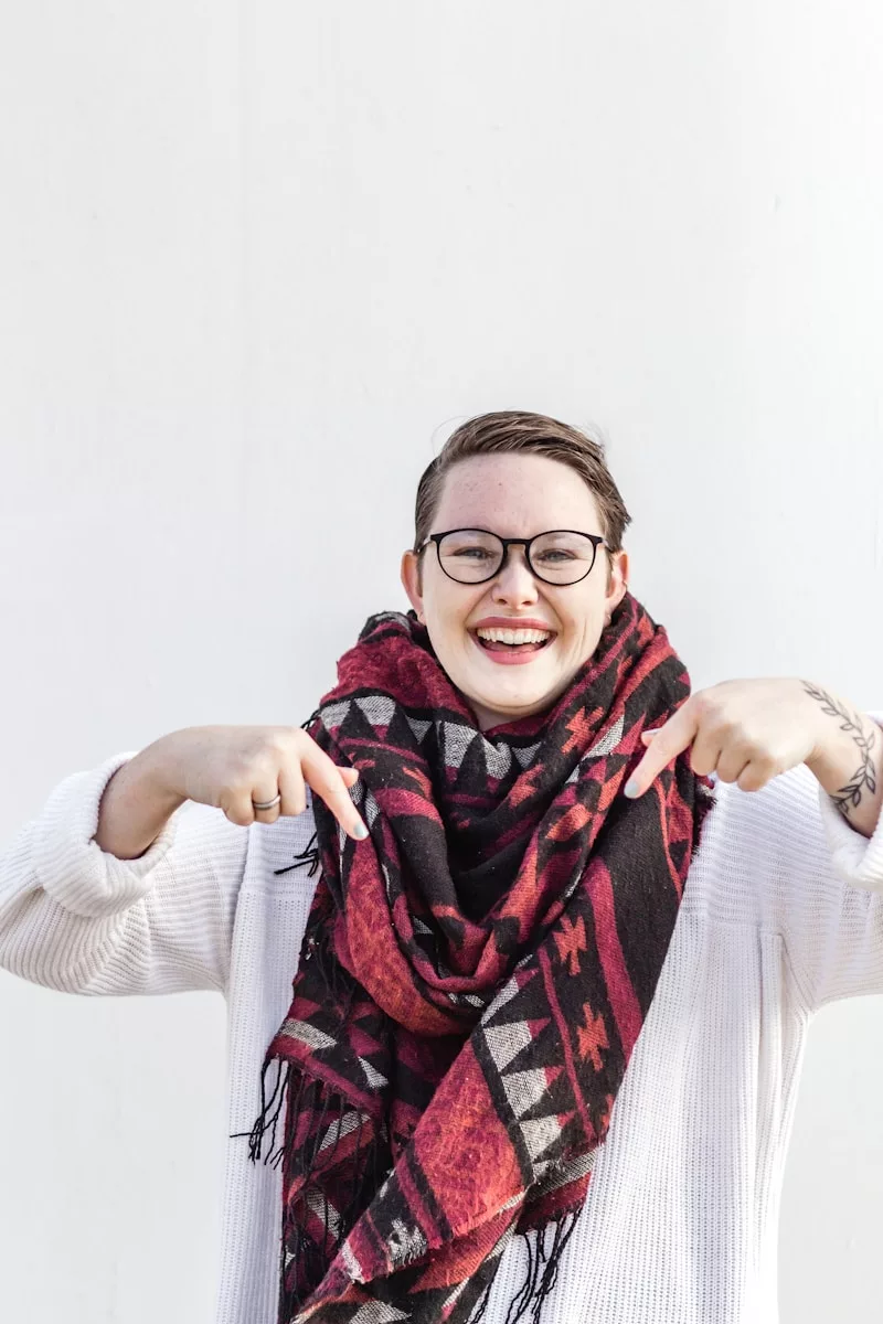 woman in white long sleeve shirt wearing red scarf and black framed eyeglasses
